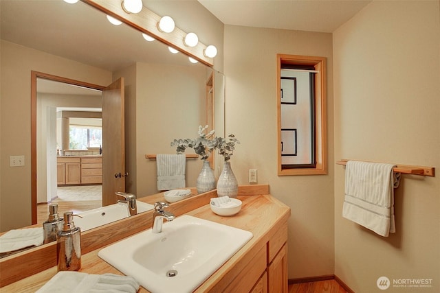 9430 Hoeder Ln, Bothell, WA 98011 - bathroom featuring vanity, wood finished floors, and baseboards