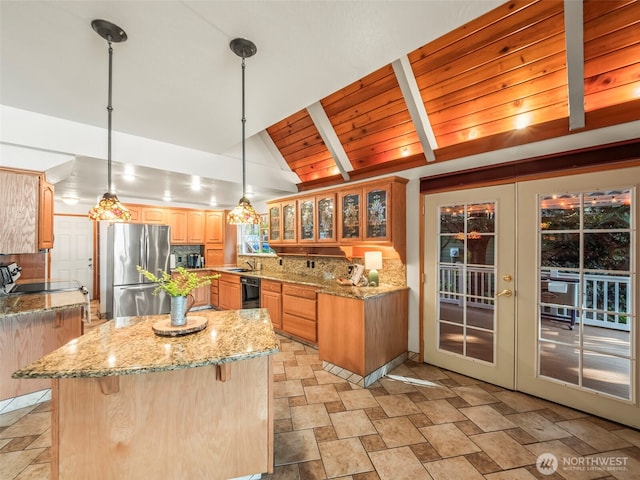 271 E Ballantrae Dr, Shelton, WA 98584 - kitchen featuring freestanding refrigerator, stone finish flooring, a center island, french doors, and light stone countertops