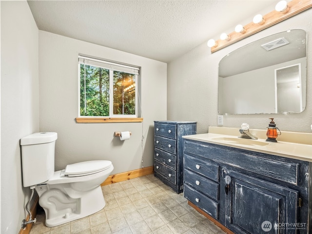 271 E Ballantrae Dr, Shelton, WA 98584 - bathroom featuring toilet, vanity, a textured ceiling, and baseboards