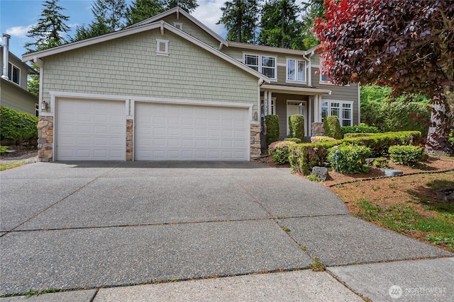 8130 104th Street Ct SW, Lakewood, WA 98498 - view of front facade featuring stone siding, driveway, and a garage