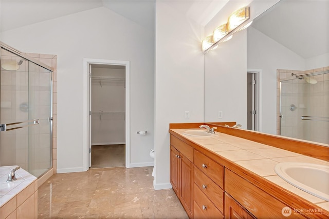 8130 104th Street Ct SW, Lakewood, WA 98498 - full bath featuring lofted ceiling, a shower stall, double vanity, a spacious closet, and toilet