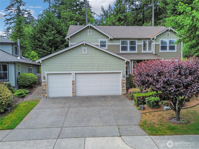 8130 104th Street Ct SW, Lakewood, WA 98498 - view of front of house with stone siding, driveway, and a garage
