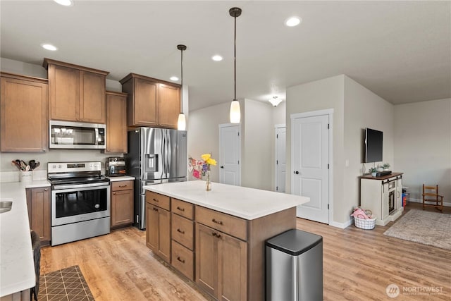 509 L NE, Quincy, WA 98848 - kitchen featuring appliances with stainless steel finishes, light wood finished floors, light countertops, recessed lighting, and hanging light fixtures