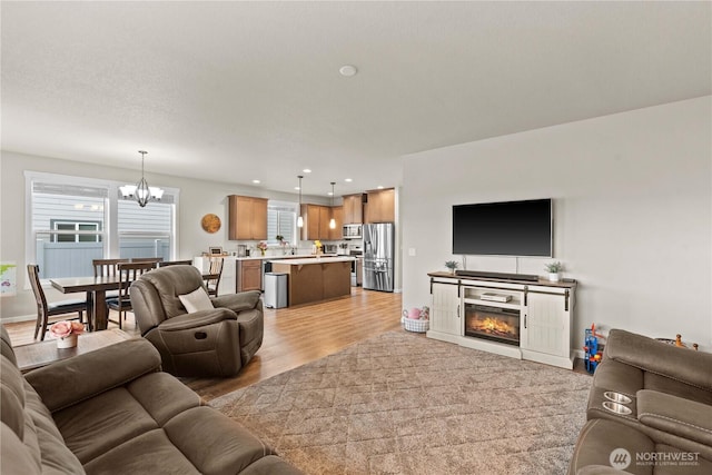 509 L NE, Quincy, WA 98848 - living area with a chandelier, light wood-type flooring, recessed lighting, and a glass covered fireplace