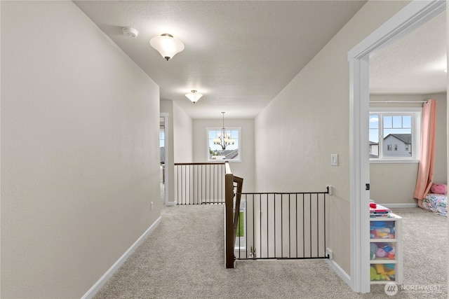 509 L NE, Quincy, WA 98848 - hall featuring carpet floors, a chandelier, an upstairs landing, and baseboards