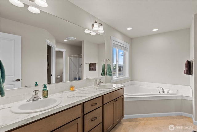 509 L NE, Quincy, WA 98848 - full bathroom with a stall shower, double vanity, a garden tub, and recessed lighting