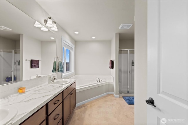 509 L NE, Quincy, WA 98848 - bathroom featuring a stall shower, a garden tub, double vanity, recessed lighting, and baseboards