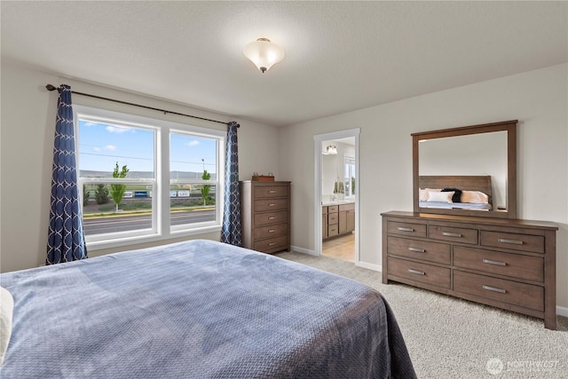 509 L NE, Quincy, WA 98848 - bedroom with light carpet, baseboards, and ensuite bathroom