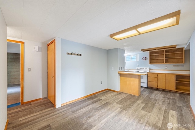 2830 Elm St, Bellingham, WA 98225 - kitchen with white electric range oven, open shelves, light wood-style floors, light countertops, and baseboards