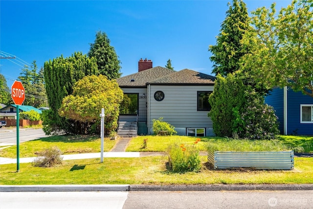 2830 Elm St, Bellingham, WA 98225 - view of front of house with a chimney, a front lawn, and roof with shingles
