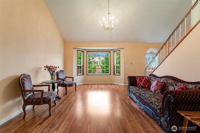 12903 SE 282nd Way, Kent, WA 98030 - living area with a chandelier, light wood-style floors, baseboards, stairway, and high vaulted ceiling