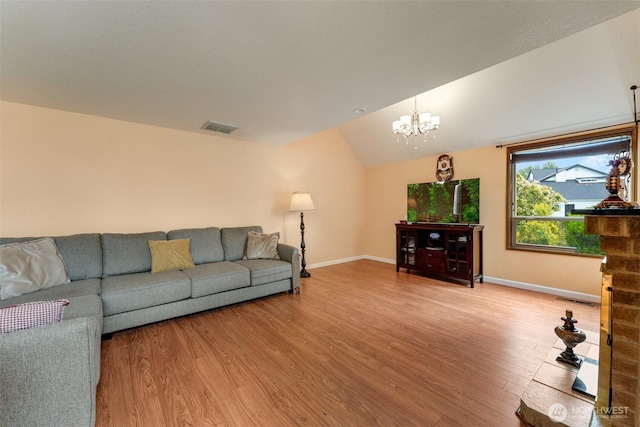12903 SE 282nd Way, Kent, WA 98030 - living room featuring light wood-style flooring, lofted ceiling, baseboards, and a chandelier