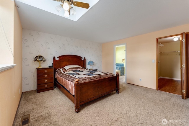 12903 SE 282nd Way, Kent, WA 98030 - bedroom with light carpet, baseboards, ensuite bathroom, a skylight, and wallpapered walls