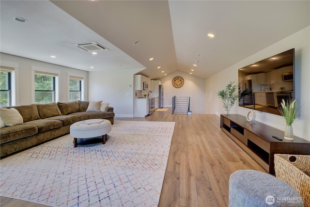 11504 128th Dr NE, Lake Stevens, WA 98258 - living room featuring light wood-type flooring, vaulted ceiling, and recessed lighting