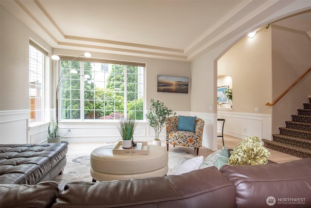19 198th Pl SE, Bothell, WA 98012 - living area featuring a raised ceiling, a wainscoted wall, wood finished floors, stairway, and a decorative wall