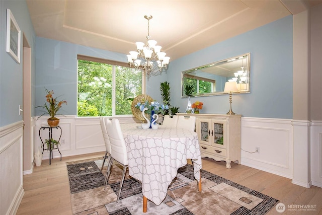 19 198th Pl SE, Bothell, WA 98012 - dining area featuring a chandelier, light wood finished floors, healthy amount of natural light, wainscoting, and a tray ceiling