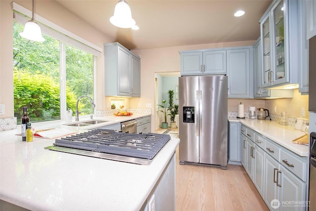 19 198th Pl SE, Bothell, WA 98012 - kitchen with stainless steel appliances, a sink, light countertops, light wood-style flooring, and recessed lighting