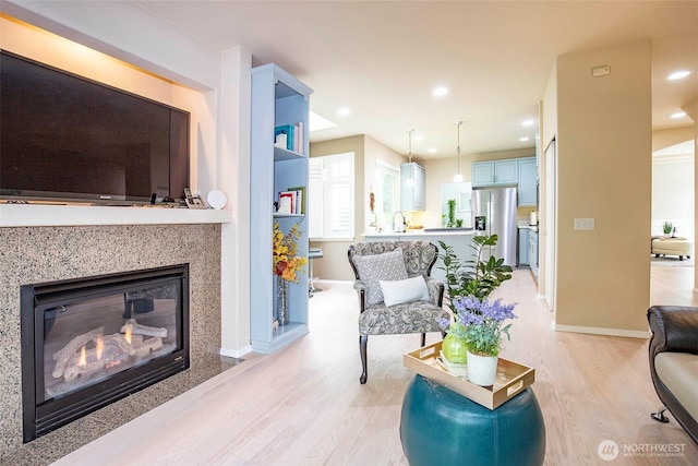 19 198th Pl SE, Bothell, WA 98012 - living area featuring light wood finished floors, a fireplace with flush hearth, baseboards, and recessed lighting