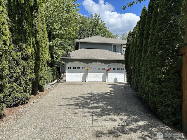 19 198th Pl SE, Bothell, WA 98012 - view of front of property with driveway, an attached garage, roof with shingles, and stone siding