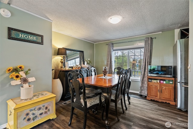 4224 N Brooks Rd, Medical Lake, WA 99022 - dining area with crown molding, a textured ceiling, and dark wood-style flooring