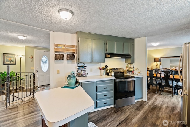 4224 N Brooks Rd, Medical Lake, WA 99022 - kitchen featuring appliances with stainless steel finishes, under cabinet range hood, a textured ceiling, light countertops, and dark wood-type flooring