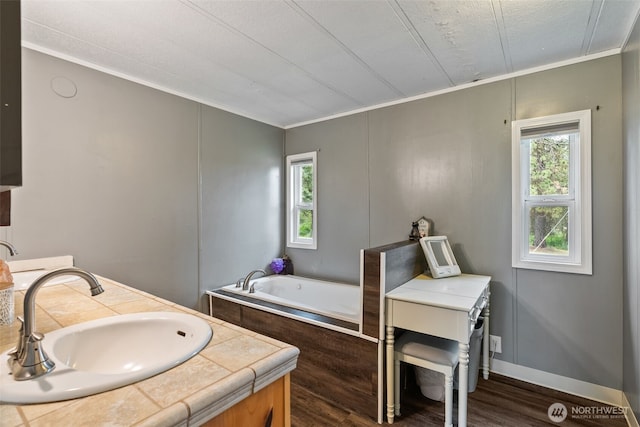 4224 N Brooks Rd, Medical Lake, WA 99022 - full bath featuring crown molding, a garden tub, plenty of natural light, wood finished floors, and double vanity