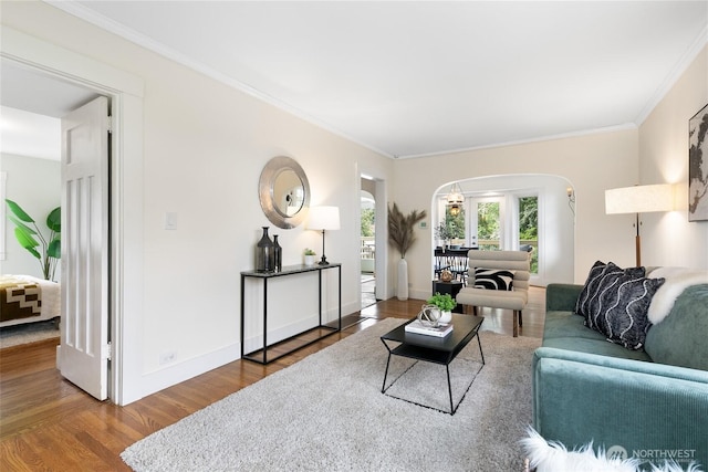 3929 SW Elmgrove St, Seattle, WA 98136 - living room with arched walkways, wood finished floors, ornamental molding, and baseboards