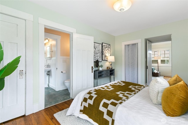 3929 SW Elmgrove St, Seattle, WA 98136 - bedroom featuring wood finished floors, connected bathroom, and baseboards