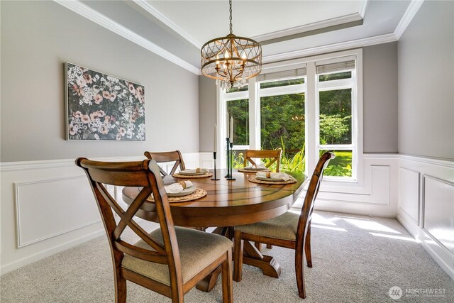 13302 53rd Ave NW, Gig Harbor, WA 98332 - carpeted dining space with a chandelier, a wainscoted wall, a raised ceiling, ornamental molding, and a decorative wall
