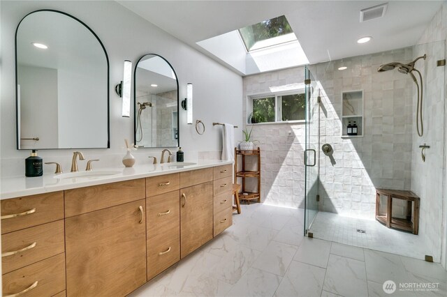 13302 53rd Ave NW, Gig Harbor, WA 98332 - full bath featuring a skylight, a shower stall, double vanity, marble look tile flooring, and recessed lighting