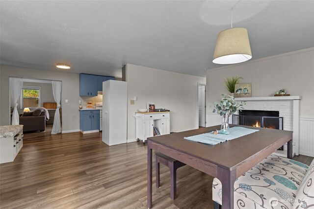 5003 219th St SW, Mountlake Terrace, WA 98043 - dining area featuring wood finished floors and a fireplace