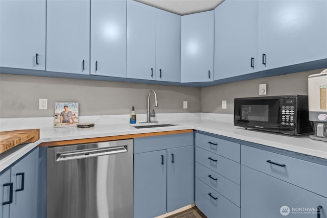 5003 219th St SW, Mountlake Terrace, WA 98043 - kitchen with stainless steel dishwasher, black microwave, a sink, and blue cabinetry