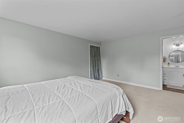 5003 219th St SW, Mountlake Terrace, WA 98043 - bedroom featuring baseboards, carpet flooring, a sink, and connected bathroom