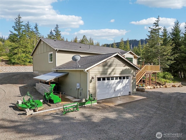 822 Filbert Rd, Cle Elum, WA 98922 - view of front of house with an attached garage, stairs, driveway, and a shingled roof