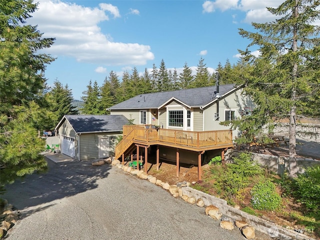 822 Filbert Rd, Cle Elum, WA 98922 - view of front of house featuring a wooden deck, asphalt driveway, stairway, and an attached garage