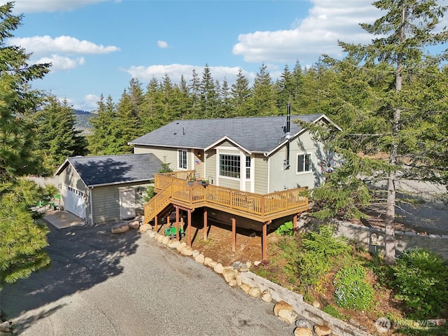 822 Filbert Rd, Cle Elum, WA 98922 - view of front of house with a deck, a garage, asphalt driveway, and a shingled roof