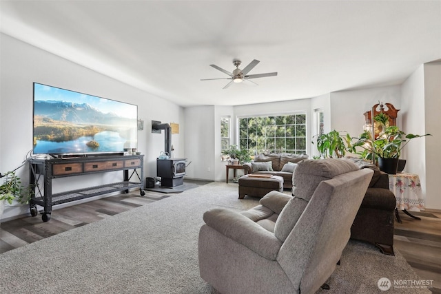 822 Filbert Rd, Cle Elum, WA 98922 - living area featuring a wood stove, wood finished floors, a ceiling fan, and baseboards