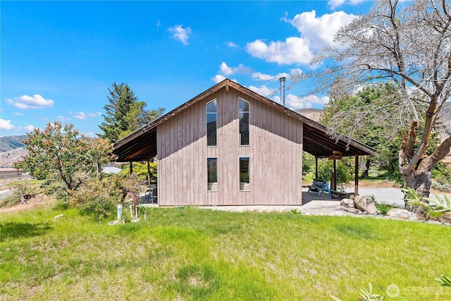 245 Lakeview Ave, Orondo, WA 98843 - view of side of home with a patio area and a lawn