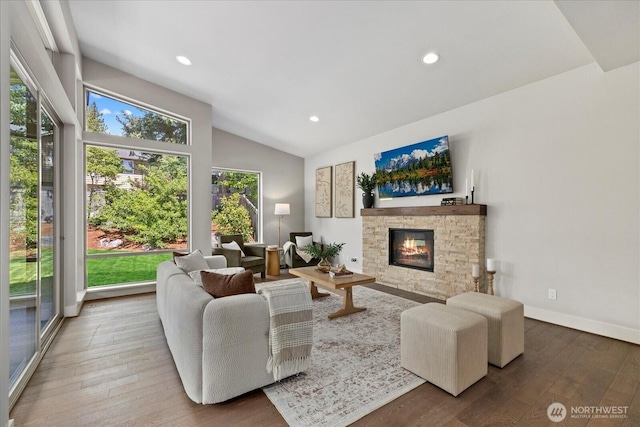 12126NE 106th Pl, Kirkland, WA 98033 - living area featuring hardwood / wood-style flooring, plenty of natural light, a stone fireplace, vaulted ceiling, and recessed lighting