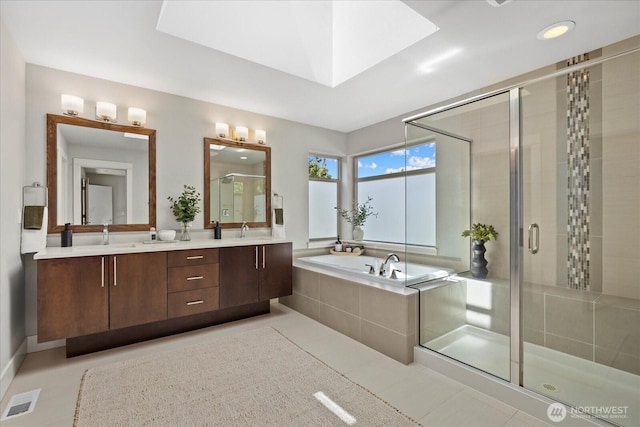12126NE 106th Pl, Kirkland, WA 98033 - full bath with a shower stall, a garden tub, double vanity, a skylight, and tile patterned floors