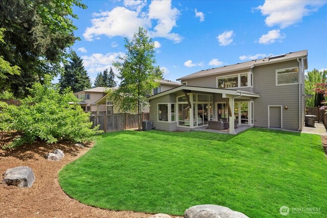 12126NE 106th Pl, Kirkland, WA 98033 - back of property with a patio area, central AC, and a sunroom