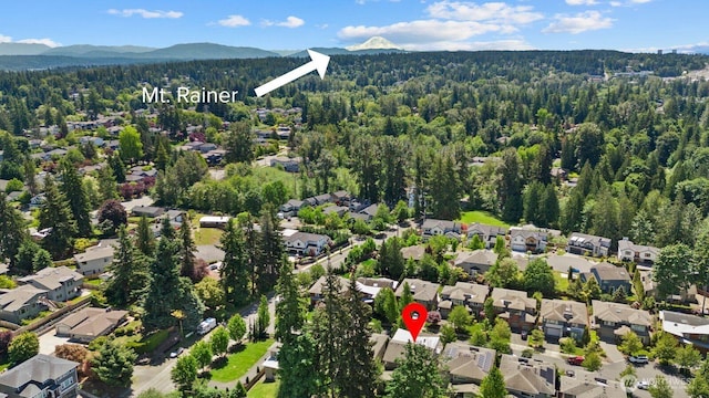 12126NE 106th Pl, Kirkland, WA 98033 - aerial view of property and surrounding area with a forest, a mountainous background, and nearby suburban area