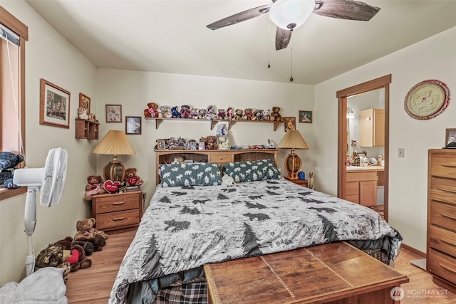 19243 Kiona Rd, Randle, WA 98377 - bedroom with light wood finished floors, ensuite bath, a ceiling fan, and baseboards