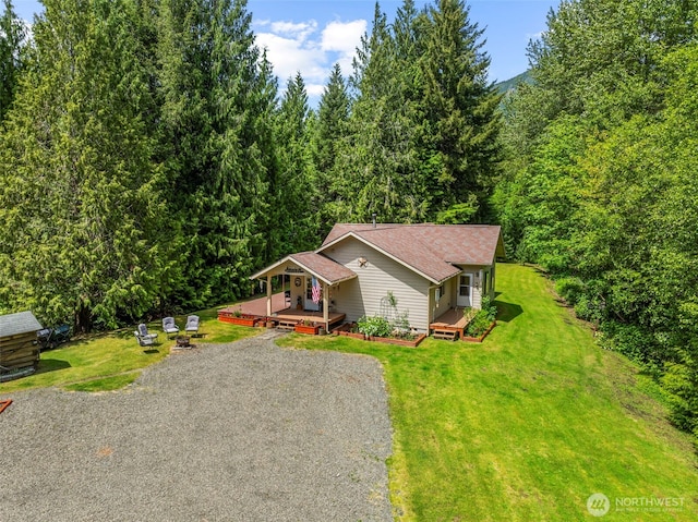 19243 Kiona Rd, Randle, WA 98377 - view of front facade with gravel driveway, a front lawn, a view of trees, and covered porch