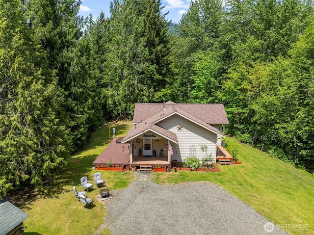 19243 Kiona Rd, Randle, WA 98377 - view of front of home with a deck, a front lawn, and a wooded view