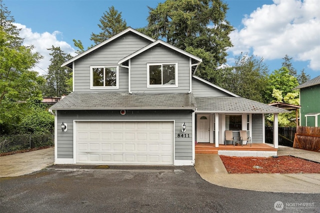 8411 68th Avenue Ct SW, Lakewood, WA 98499 - view of front of property featuring a porch, a shingled roof, asphalt driveway, and an attached garage
