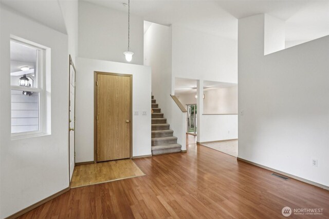 8411 68th Avenue Ct SW, Lakewood, WA 98499 - foyer entrance featuring a towering ceiling, stairs, and wood finished floors
