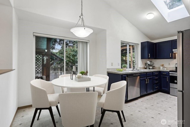 8411 68th Avenue Ct SW, Lakewood, WA 98499 - kitchen featuring appliances with stainless steel finishes, blue cabinets, a skylight, healthy amount of natural light, and high vaulted ceiling