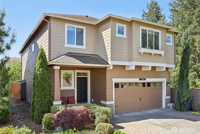 1903 98th Ave SE, Lake Stevens, WA 98258 - view of front of house featuring an attached garage, driveway, and stone siding