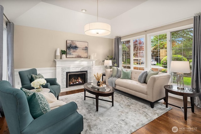 24228 SE 47th St, Sammamish, WA 98029 - living area featuring wood finished floors, a fireplace, and a wainscoted wall
